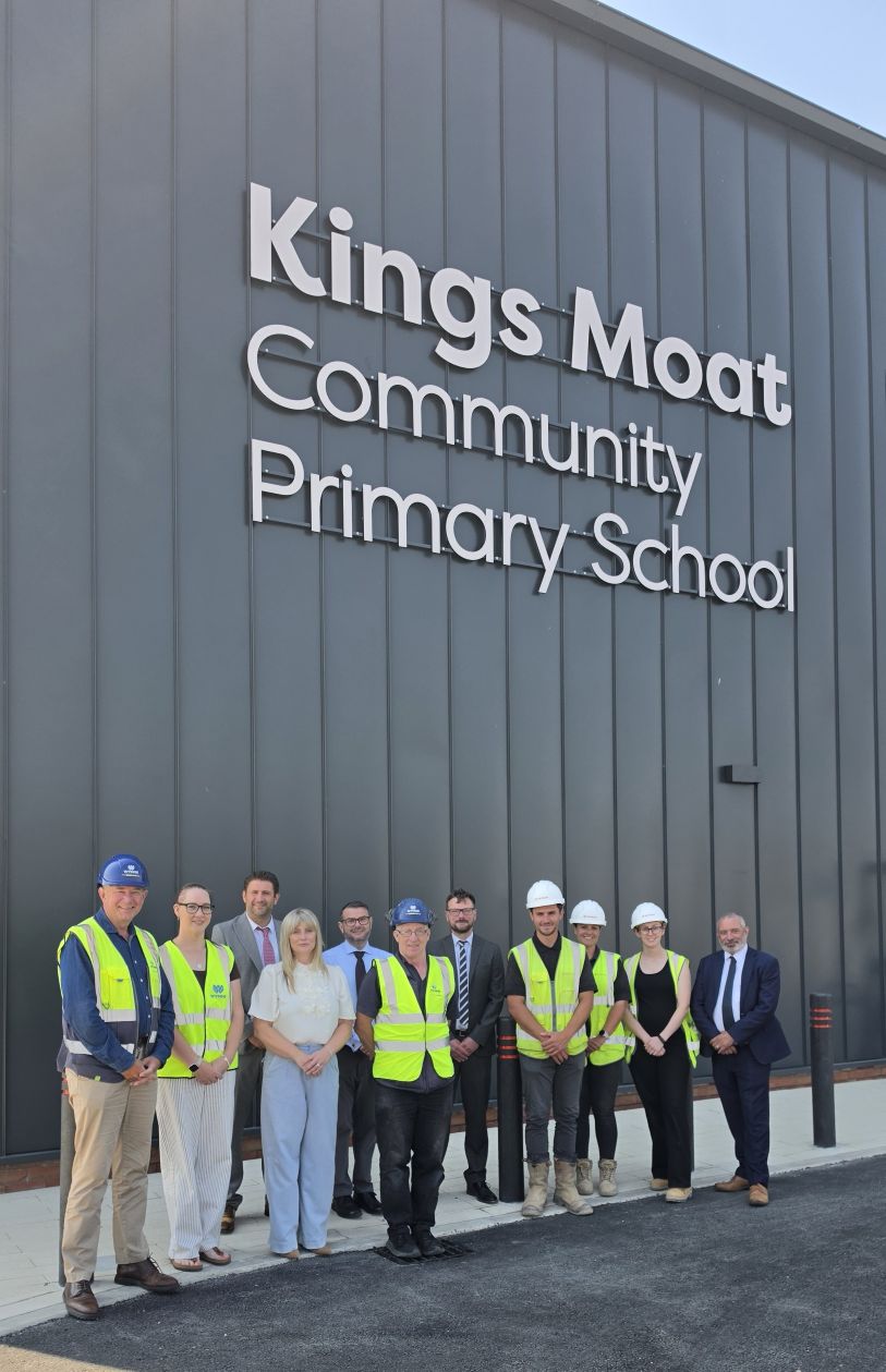 Adults gather outside Kings Moat Community Primary School