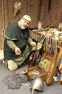 A member of the Education team with some of the objects from the Viking and Saxons collection bought for Weaver Hall and Workhouse by the museum's Friends group.