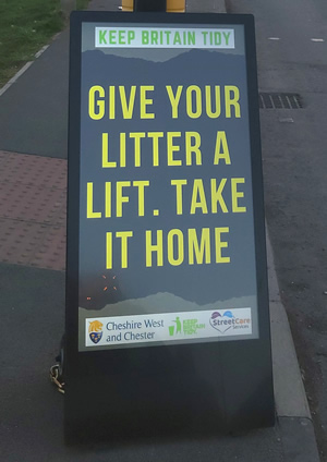 Digital signage saying Keep Britain Tidy, Give your litter a lift. Take it home.