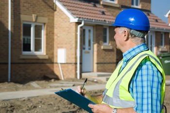 Building control inspector looking at homes