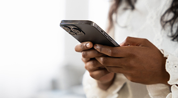 Closeup of hands using phone.