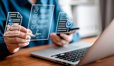Businesswomen using a stylus pen to sign one document on a virtual notebook screen.