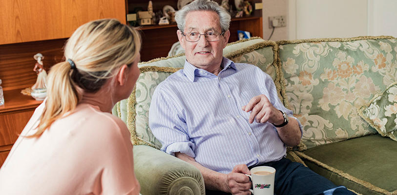 Two people talking in a living room