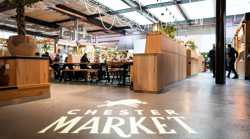 Chester Market interior shot of the atrium, with market the logo shown projected on the floor.