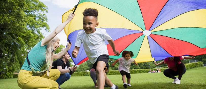 Child running under parachute