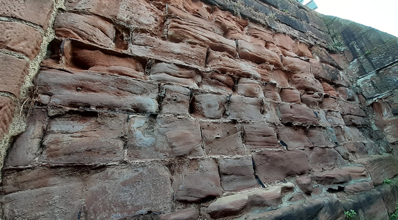 An example of hard cement mortar standing proud between eroded sandstone