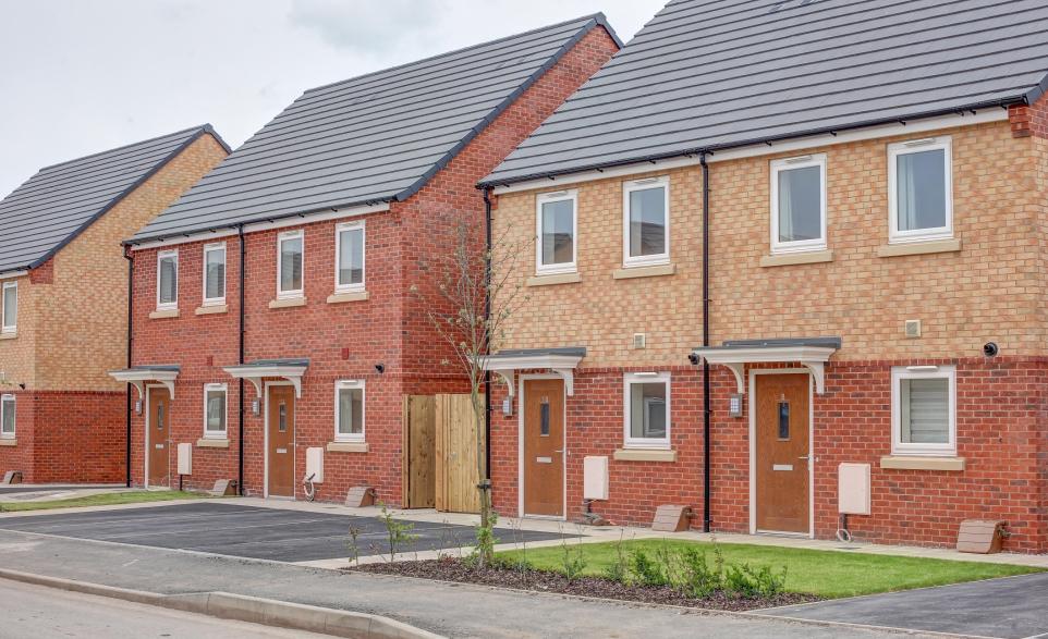 Row of semi-detached houses on street with front garden areas.