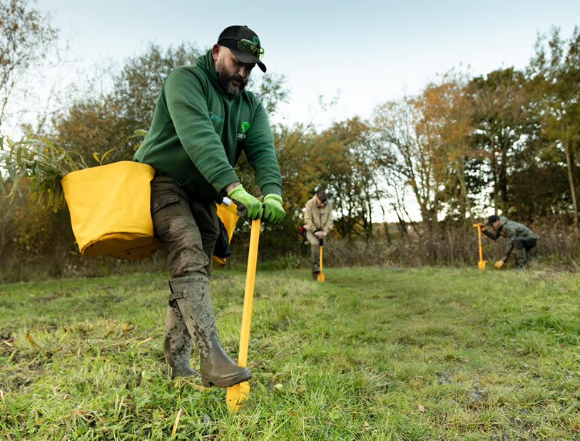 Members of the Green Task Force helping to plant tress that will grow the Mersey Forest.