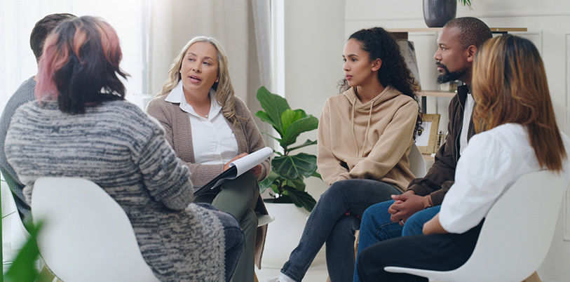 Group discussion with diverse selection of people talking about health and wellbeing.