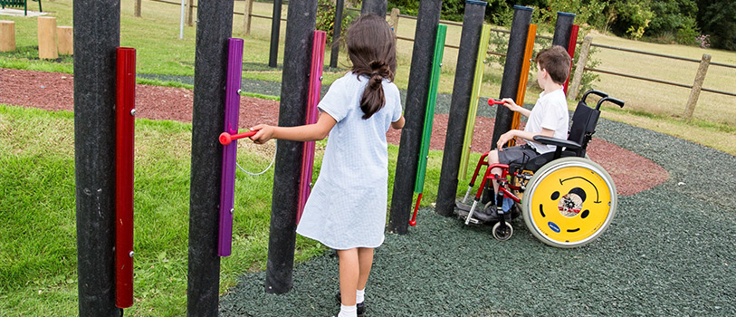 Children playing at an inclusive play area