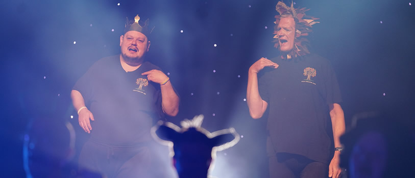 Two people on a stage giving a live performance. 
