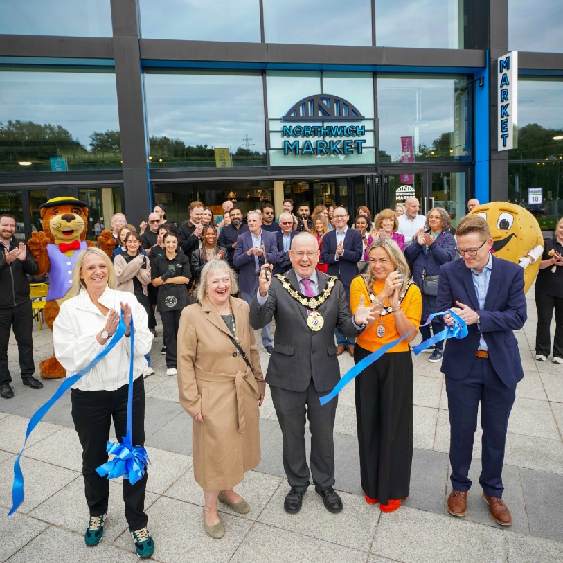 Opening of Northwich market, with group of people cutting blue ribbon tape.