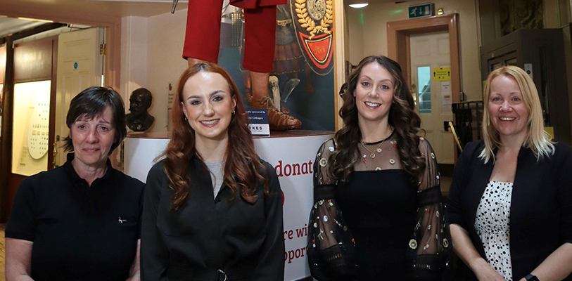 Kate Harland, Museums and Heritage Manager, Brittany Lange and Chloe Jones from Sykes Holiday Cottages and Elizabeth Montgomery, Senior Curator, next to the model of the Roman Soldier at the Grosvenor Museum.