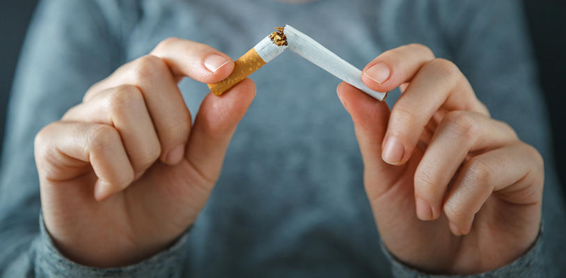 Someone breaking a ciggarette in half