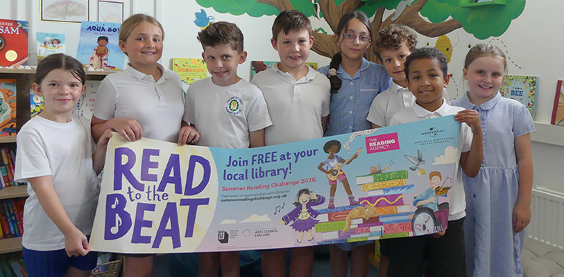 Pupils from Helsby Hillside Primary School with a banner for this year's Summer Reading Challenge.