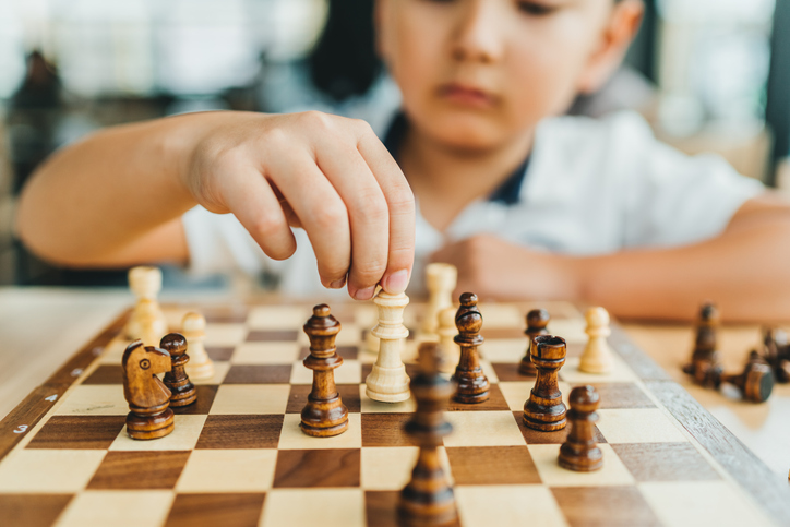 Boy play chess in interior stock photo