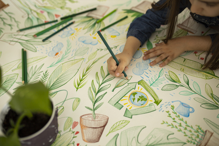 Top view of a little girl drawing and coloring on paper stock photo