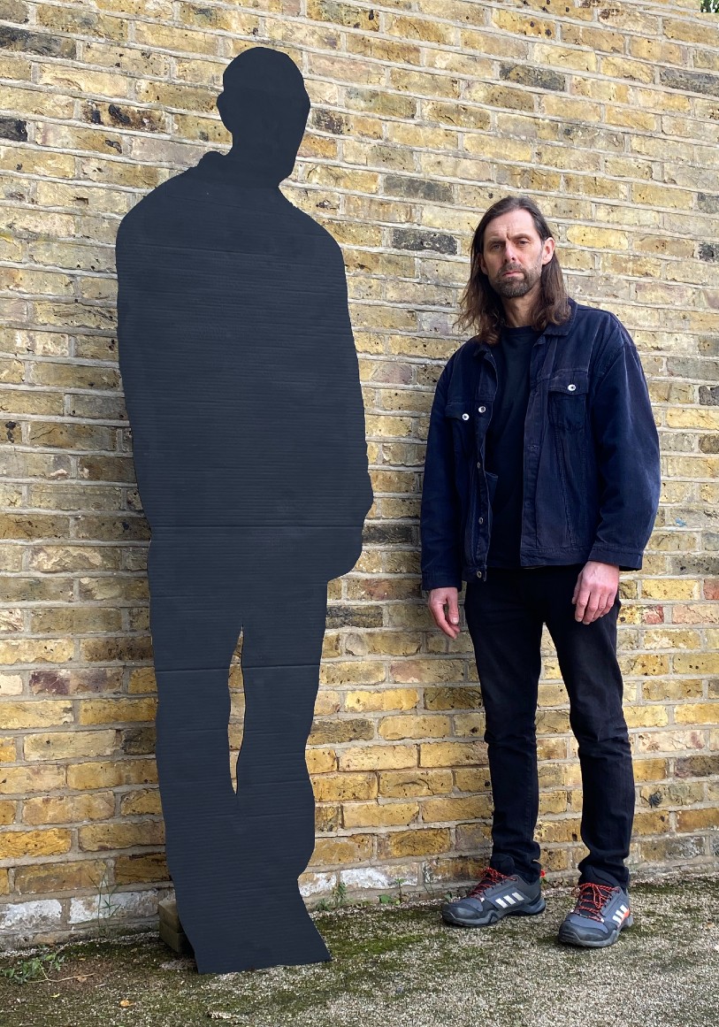 Artist Mark Titchner with an example of a shadow portrait