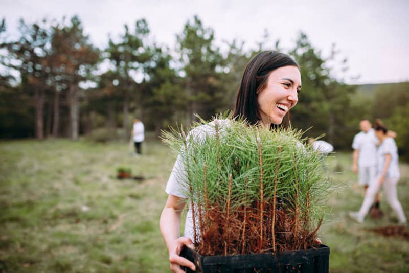 Woman holding plants.