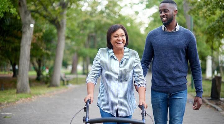 A care worker walking in the park with another person