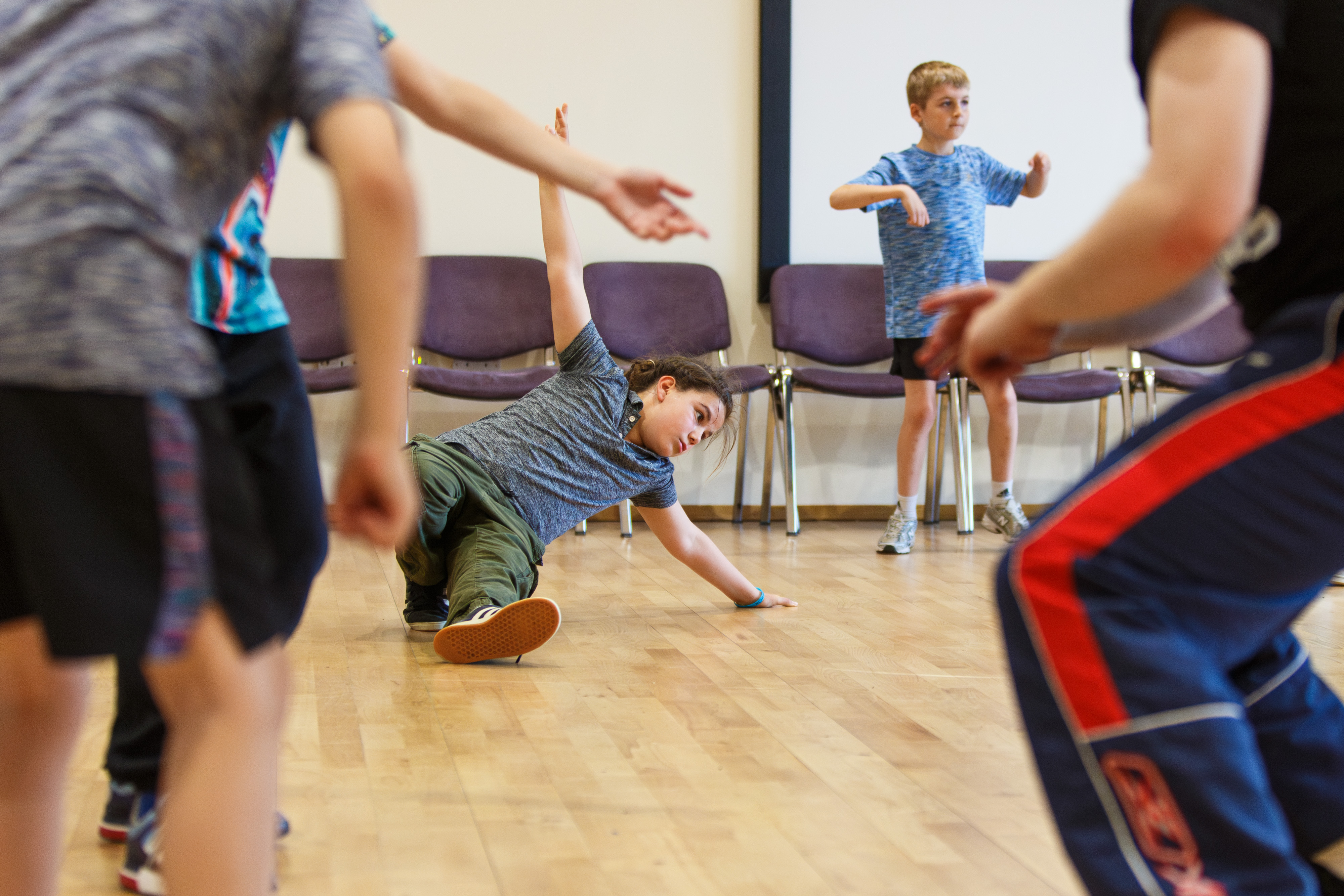 group of children learning dance moves