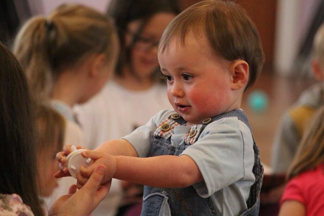 a baby holding a toy