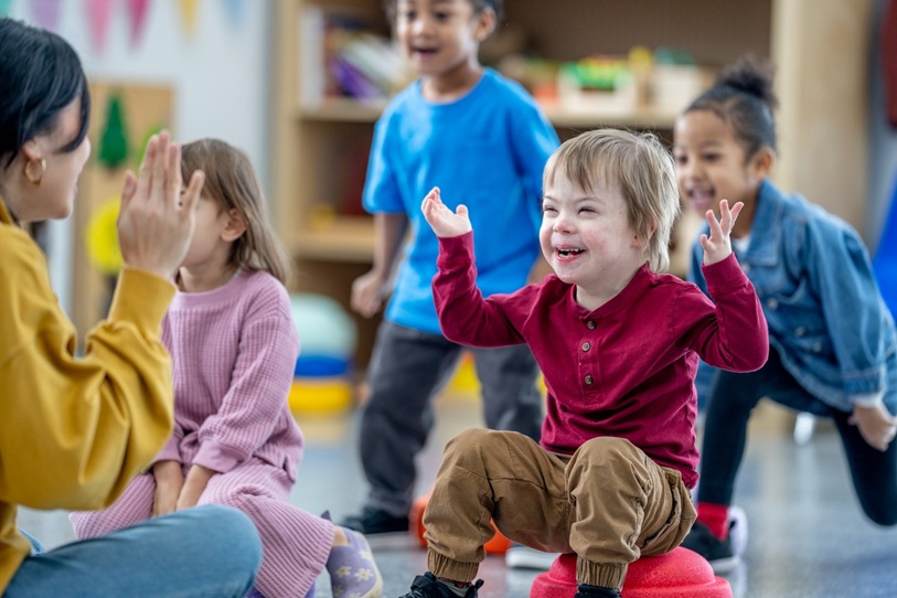 Young children with happy, smiley faces enjoying a game together. 