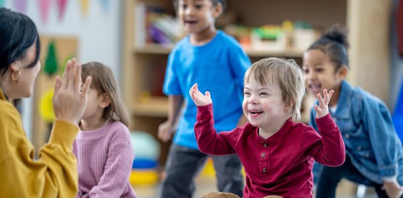 Young children with happy, smiley faces enjoying a game together.