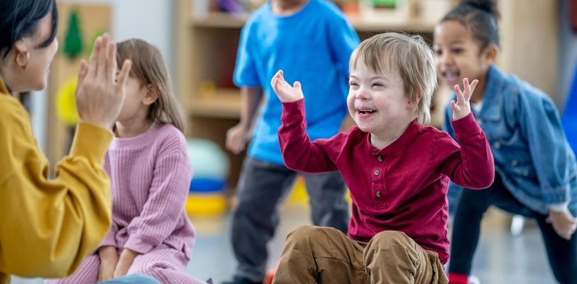 Young children with happy, smiley faces enjoying a game together.