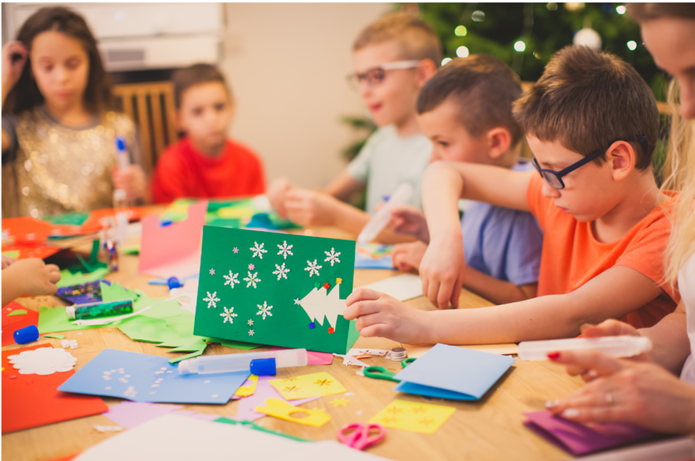 A group of children making Christmas cards