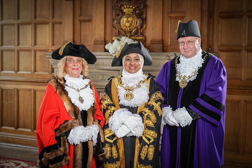 Three people in ceremonial robes