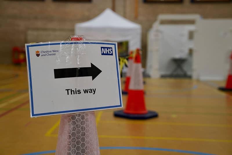 NHS sign arrow pointing right with 'This Way' beneath