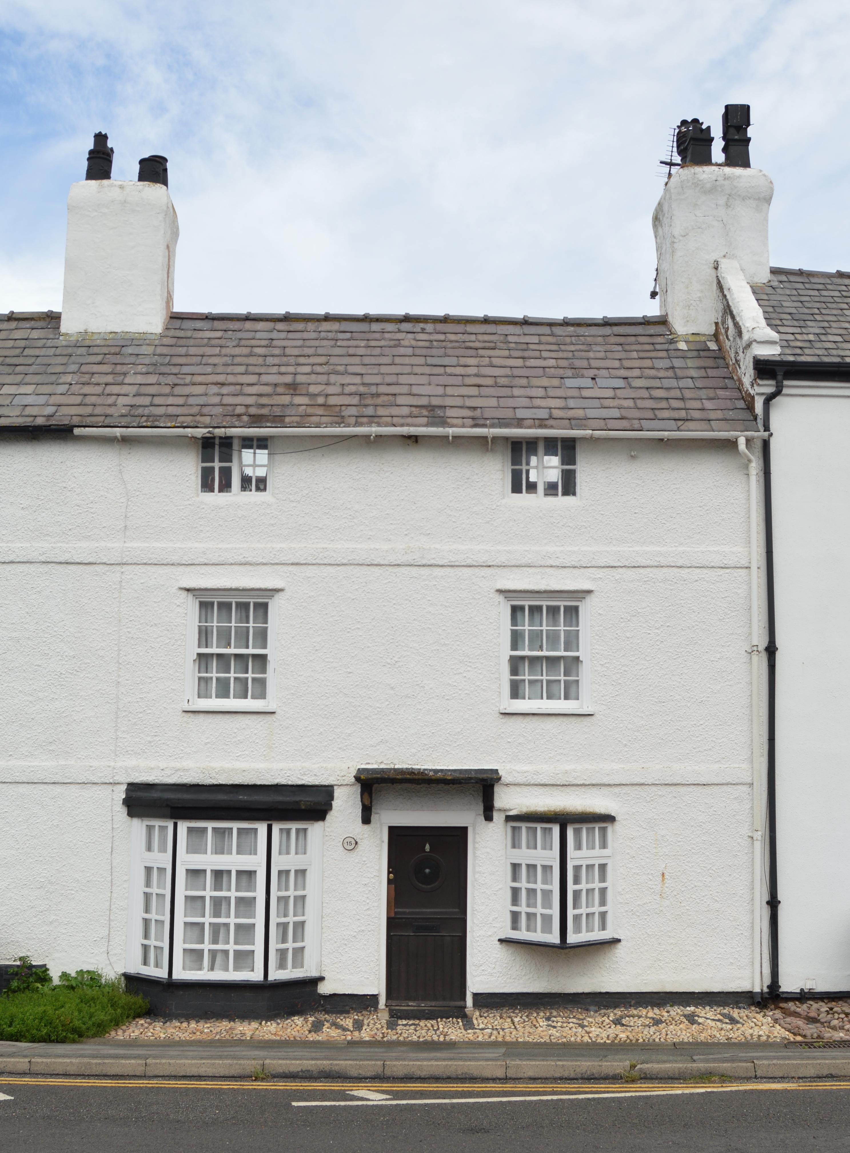 A simple black painted plinth helps to ground this dwelling in Parkgate.
