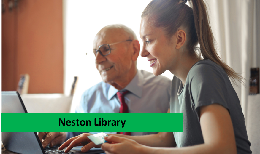Older man with younger woman in front of a laptop