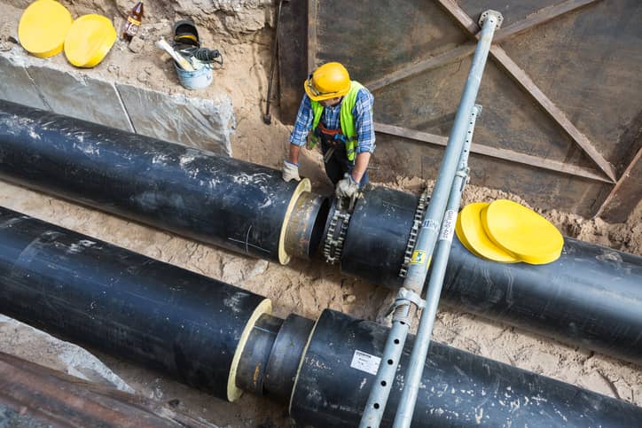 Construction worker fixing drains