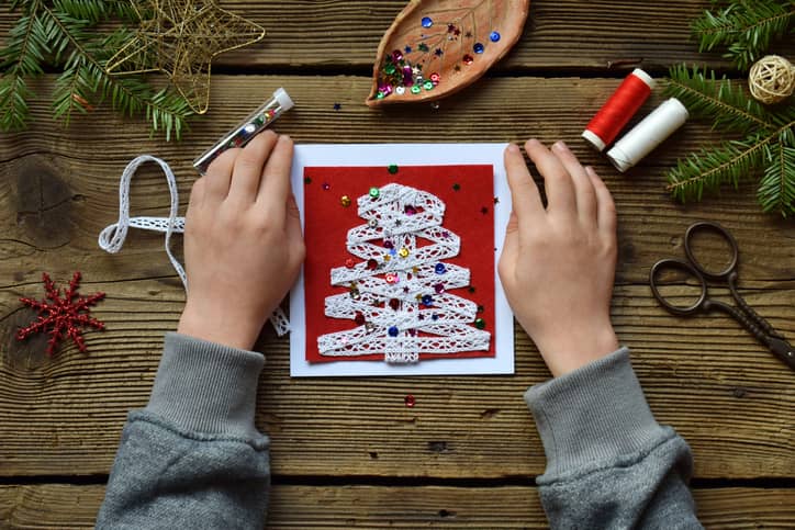 Child making creative Christmas card