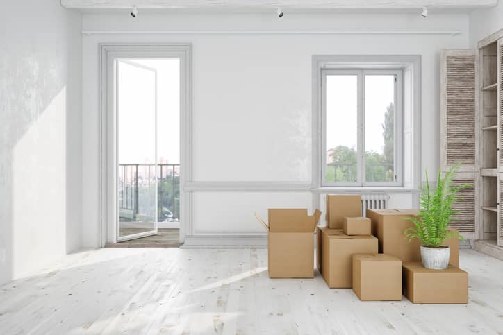 Empty home with all the furniture packed up in cardboard boxes