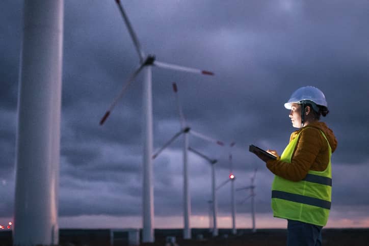 HyNet employee looking at wind turbines