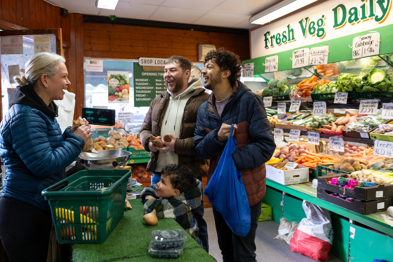 People shopping for healthy food in a greengrocer's shop.