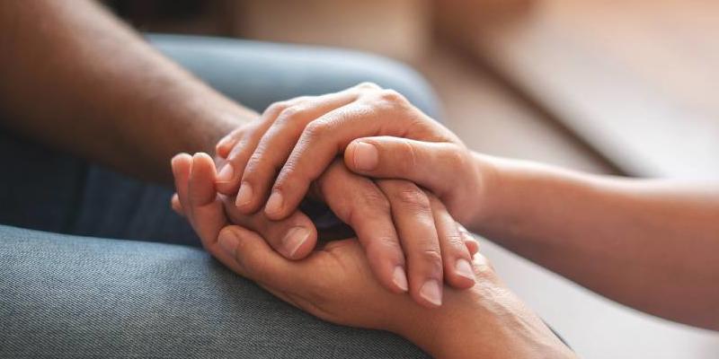Two people holding hands