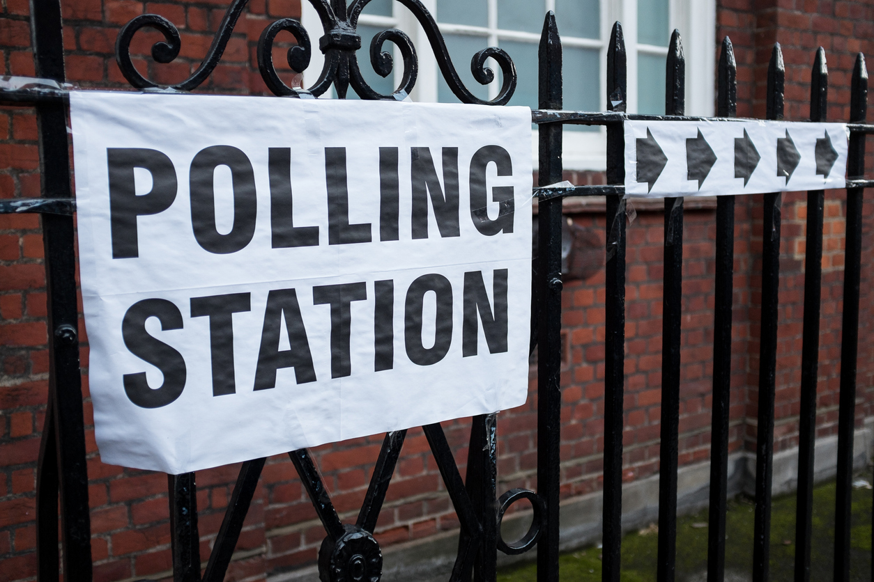 A building that has a large banner that reads Polling Station.