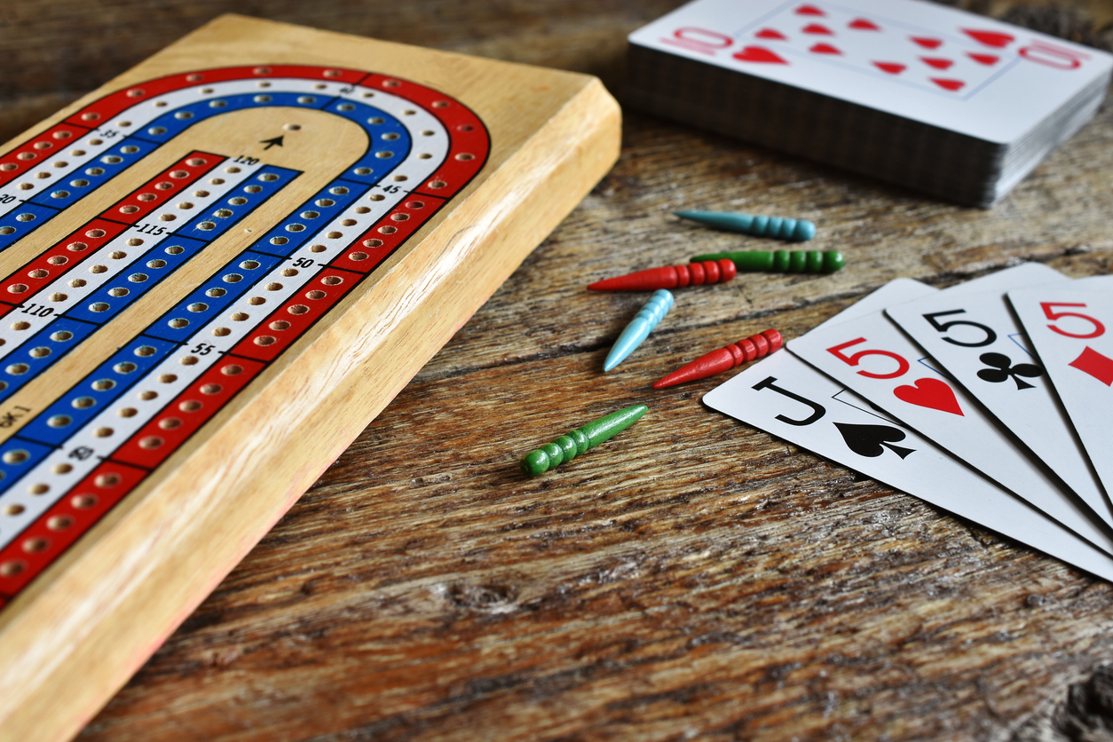 closeup of a pack of cards sand cribbage board