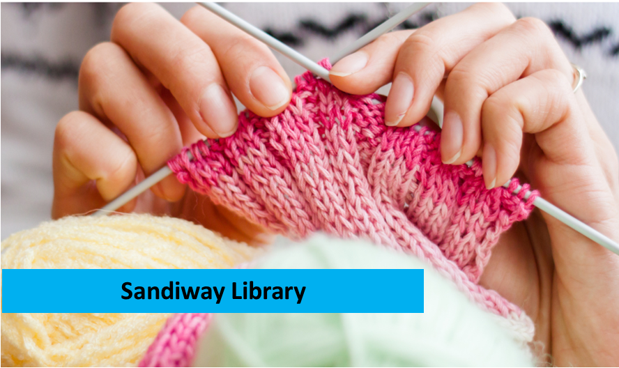 hands knitting a pink scarf