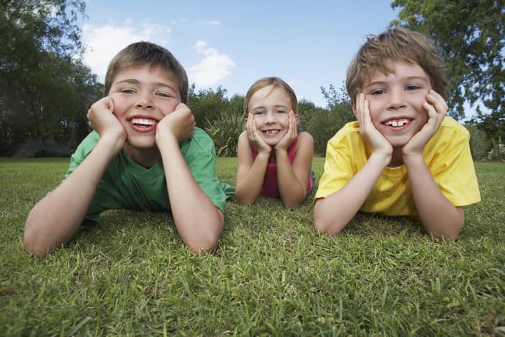 Three children smiling