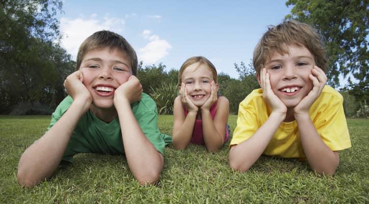 Children laying on the grass