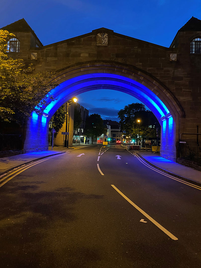 Picture of Newgate illuminated at night.