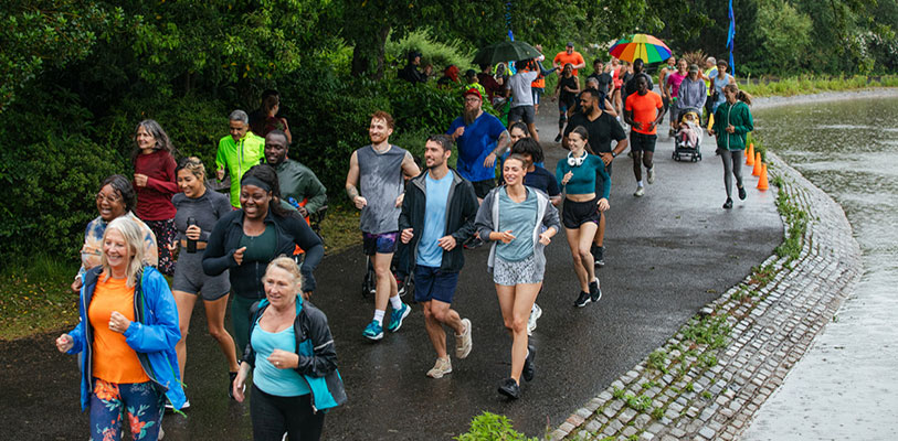 Runners jogging in park as part of a Parkrun event