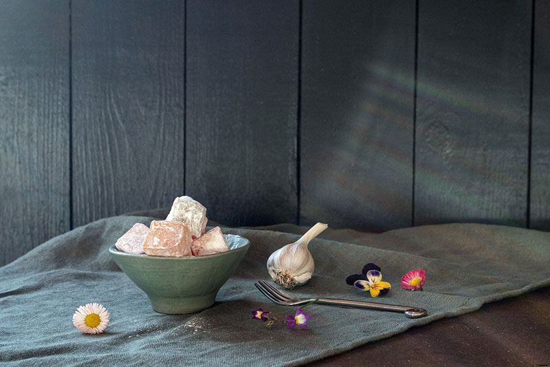 Still life photography featuring food and flowers.