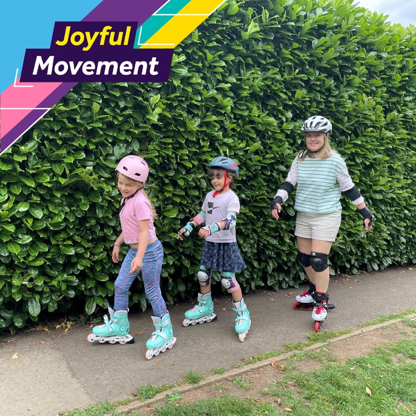 Two seven-year-old girls and a woman enjoy rollerblading. The text says 'Joyful Movement'.