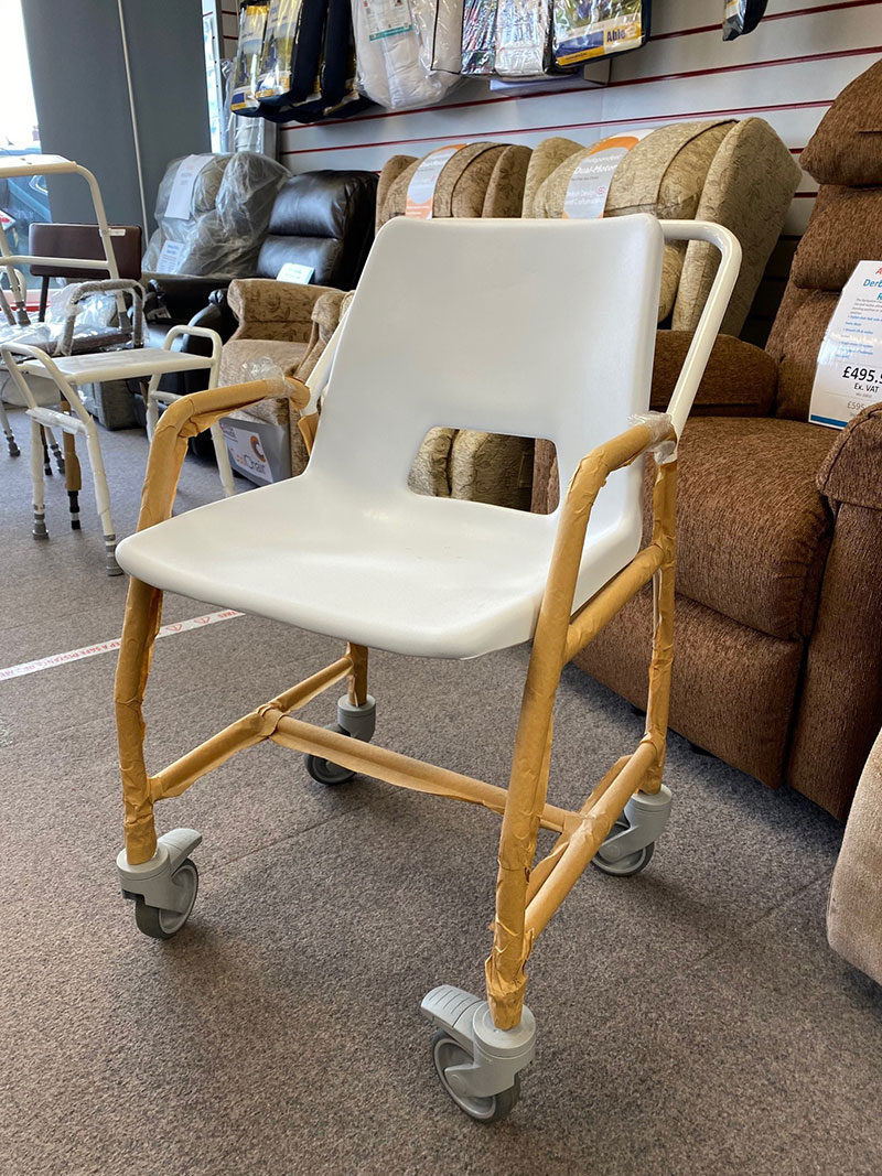 Ross Care mobile shower chair with castors.